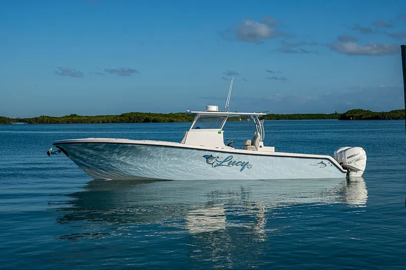 Slide: The Image of 2021 Streamline 35 CC boat on calm water under clear blue sky. - 39