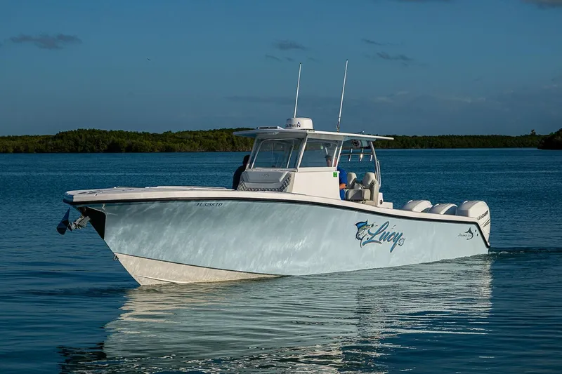 Slide: The Image of 2021 Streamline 35 CC boat cruising on calm water under clear skies. - 42