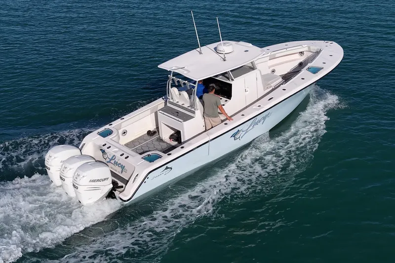 Slide: The Image of 2021 Streamline 35 CC boat cruising on clear blue water. - 44