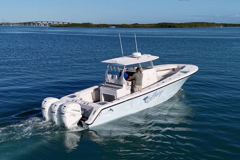 Slide: The Image of 2021 Streamline 35 CC boat cruising on calm blue waters with triple Mercury engines. - 46