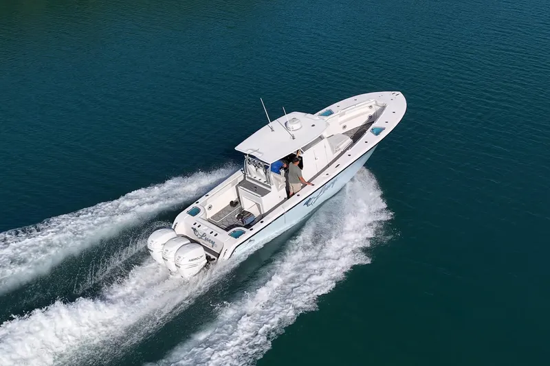 Slide: The Image of 2021 Streamline 35 CC boat cruising on clear blue water, showcasing powerful engines. - 52