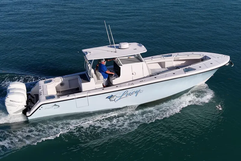 Slide: The Image of 2021 Streamline 35 CC boat cruising on open water with dual Mercury engines. - 53