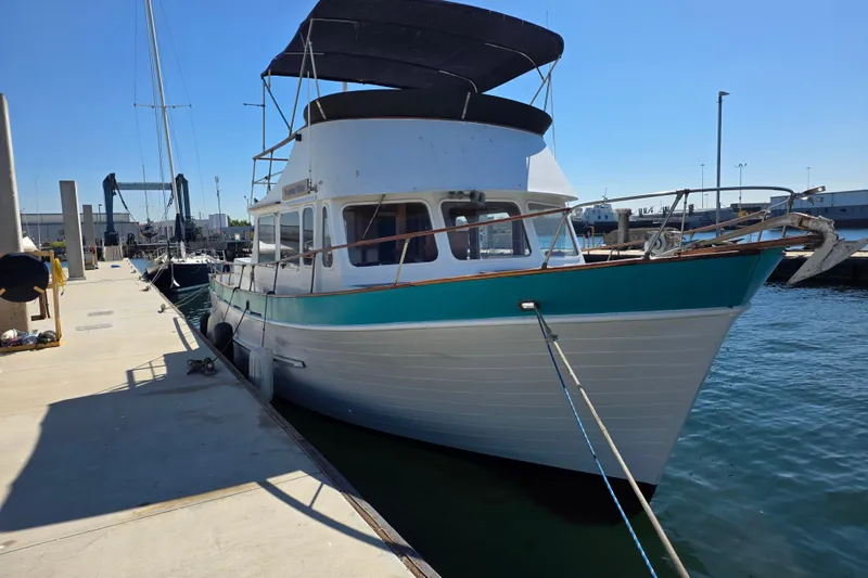The Image of 1970 Defver 40 boat docked at marina under clear blue sky. - 0