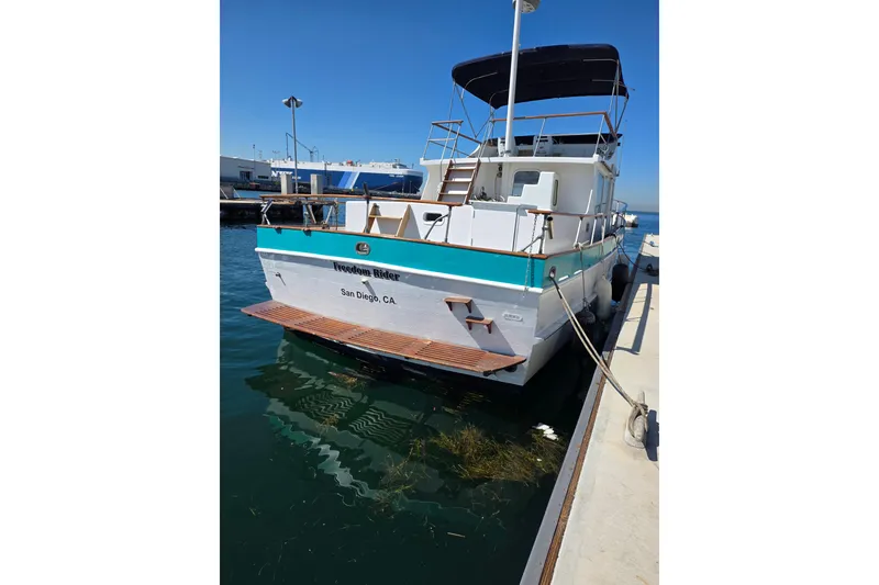 Slide: The Image of 1970 Defver 40 boat docked in San Diego marina under clear blue sky. - 3