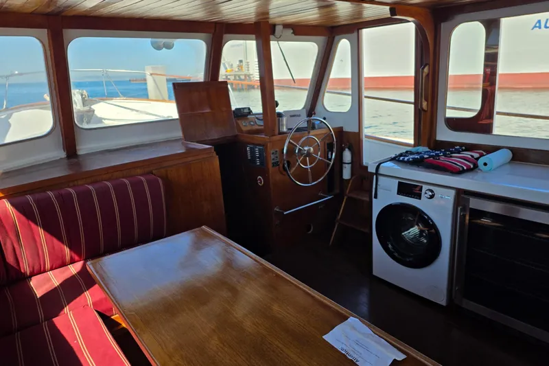 Slide: The Image of Interior of a 1970 Defver 40 boat with wooden furnishings and a washing machine. - 4