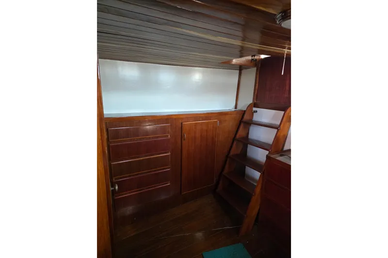 Slide: The Image of Interior of a 1970 Defver 40 boat with wooden cabinetry and ladder. - 7