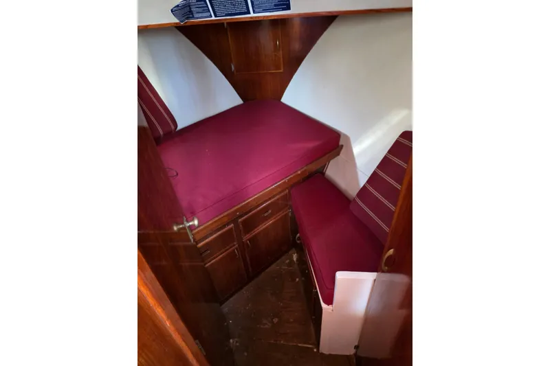 Slide: The Image of 1970 Defver 40 boat cabin with red cushions and wooden interior. - 8
