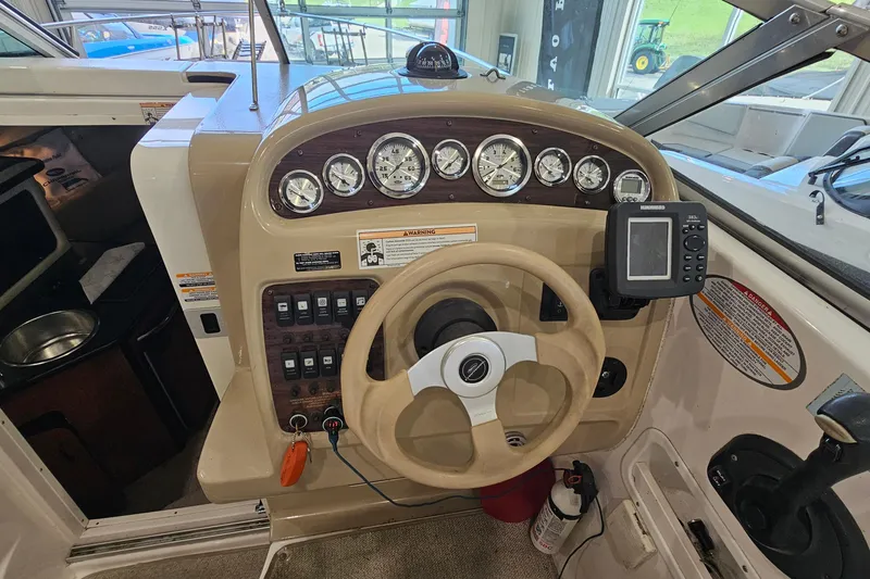 Slide: The Image of 2001 Chaparral Signature 240 boat dashboard with gauges, steering wheel, and navigation equipment. - 10