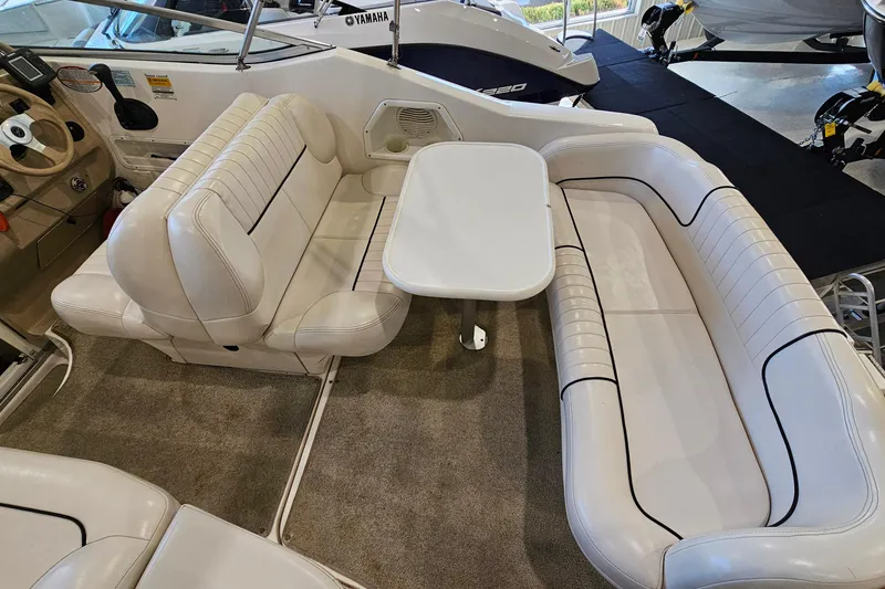 Slide: The Image of 2001 Chaparral Signature 240 boat interior with white seating and table setup. - 11