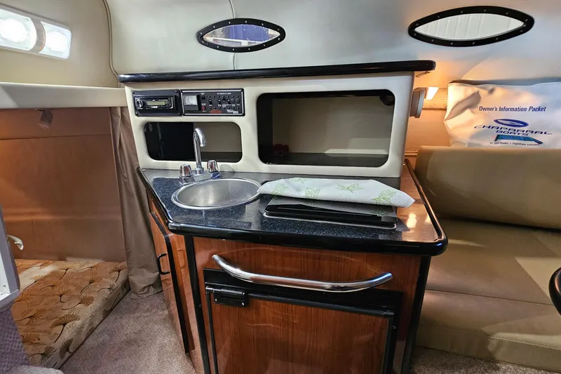 Slide: The Image of 2001 Chaparral Signature 240 cabin interior with kitchenette and seating area. - 14