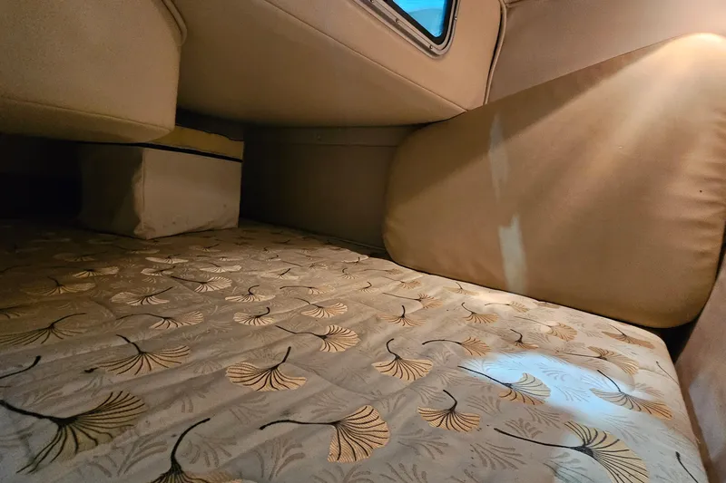 Slide: The Image of Interior cabin of 2001 Chaparral Signature 240 with patterned bedding and window. - 16