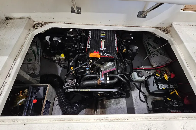 Slide: The Image of Engine compartment of a 2001 Chaparral Signature 240 boat, featuring a Mercury 5.7L engine. - 19