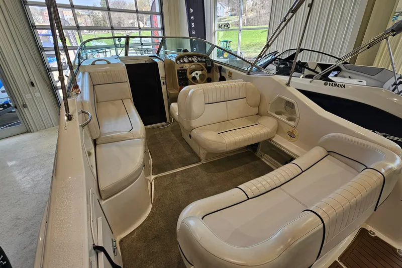 Slide: The Image of 2001 Chaparral Signature 240 boat interior with beige seating and dashboard view. - 5