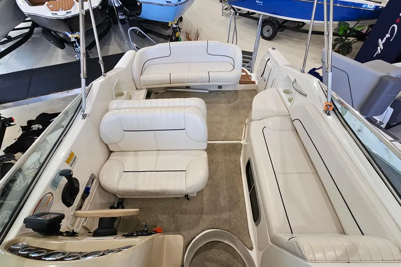 Slide: The Image of 2001 Chaparral Signature 240 boat interior with white seating and steering console. - 6