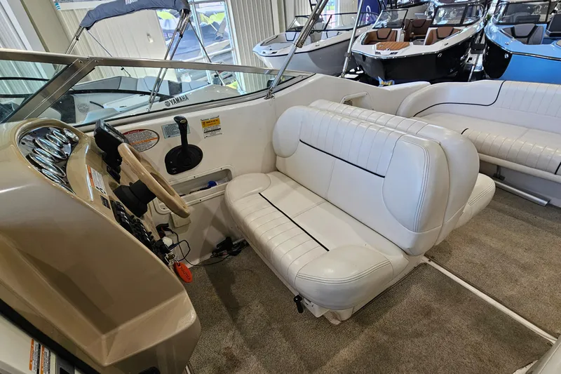 Slide: The Image of 2001 Chaparral Signature 240 boat interior with white seating and steering console. - 9