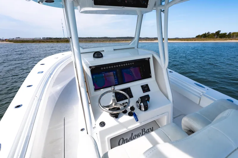 Slide: The Image of 2019 Onslow Bay 33 Tournament boat dashboard with navigation system on open water. - 14