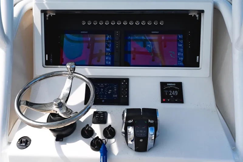 Slide: The Image of 2019 Onslow Bay 33 Tournament boat console with steering wheel and navigation display. - 15