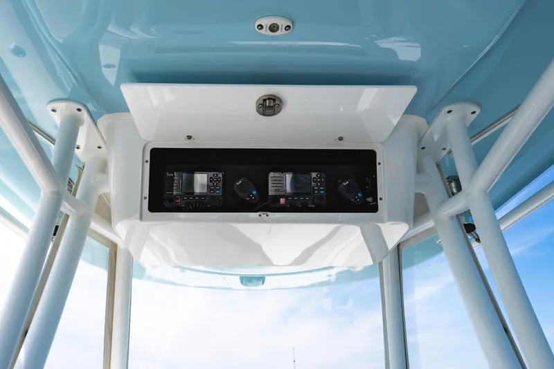 Slide: The Image of 2019 Onslow Bay 33 Tournament boat console with blue canopy and ocean view. - 17