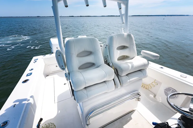 Slide: The Image of 2019 Onslow Bay 33 Tournament boat with dual white captain's chairs on open water. - 18