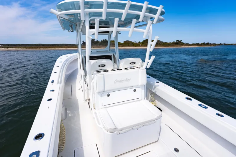 Slide: The Image of 2019 Onslow Bay 33 Tournament boat on calm water, featuring sleek design and spacious deck. - 22