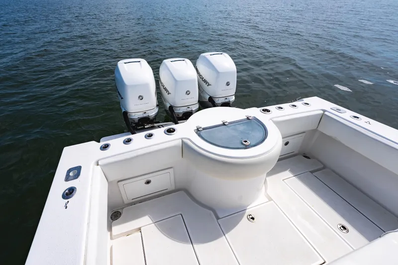 Slide: The Image of 2019 Onslow Bay 33 Tournament boat with triple outboard engines on open water. - 24