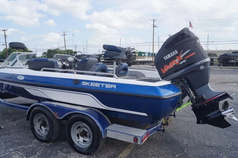 Slide: The Image of 2007 Skeeter SL 210 boat with Yamaha VMAX engine on trailer in parking lot. - 16