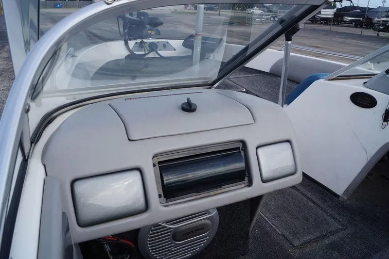 Slide: The Image of 2007 Skeeter SL 210 boat dashboard with open windshield and visible speaker system. - 18