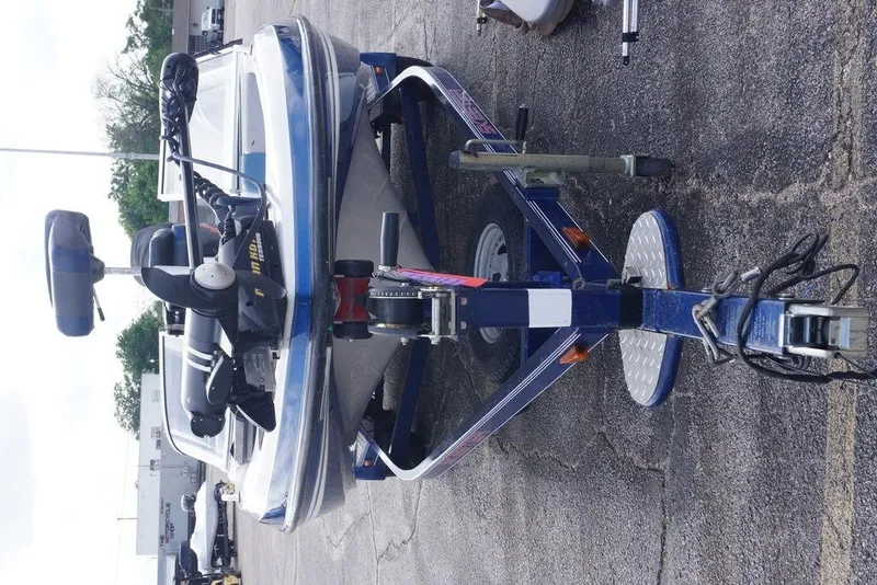Slide: The Image of 2007 Skeeter SL 210 boat on trailer, parked on asphalt. - 3