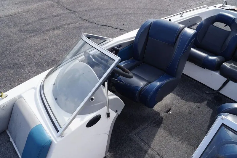 Slide: The Image of 2007 Skeeter SL 210 boat interior with blue and gray seating and steering wheel. - 8