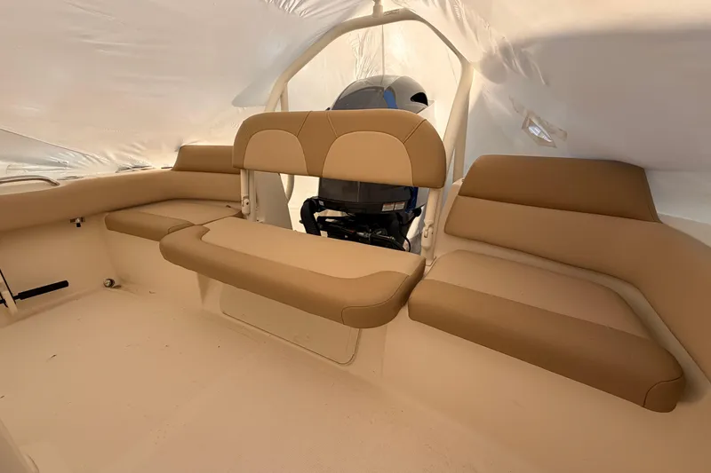 Slide: The Image of Interior of 2020 Scout 195 Sportfish boat with beige seating and motor view. - 10