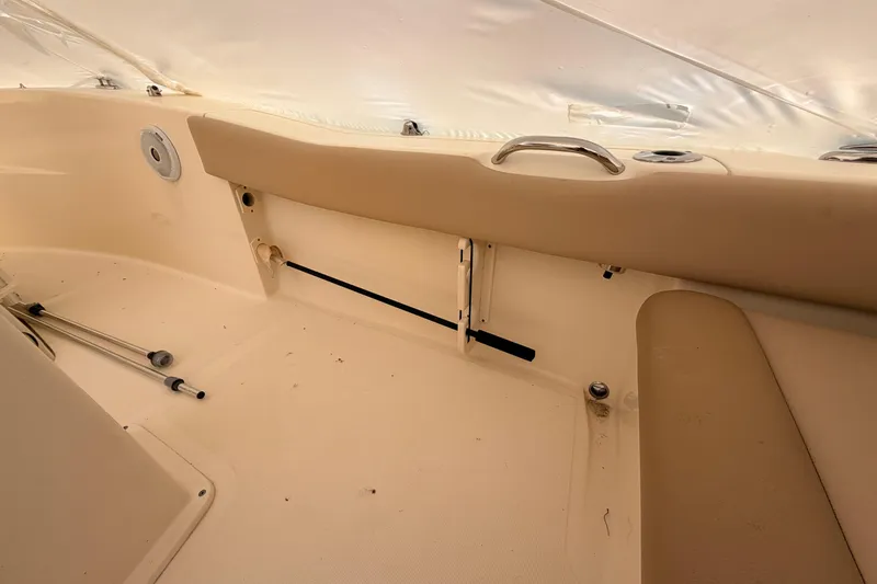 Slide: The Image of Interior of a 2020 Scout 195 Sportfish boat, featuring beige seating and storage compartments. - 11