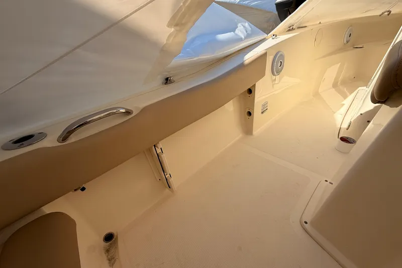 Slide: The Image of 2020 Scout 195 Sportfish boat interior with beige seating and storage compartments. - 12