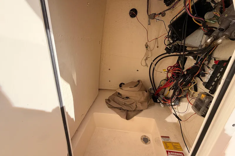 Slide: The Image of Interior wiring of a 2020 Scout 195 Sportfish boat, showing cables and storage area. - 16