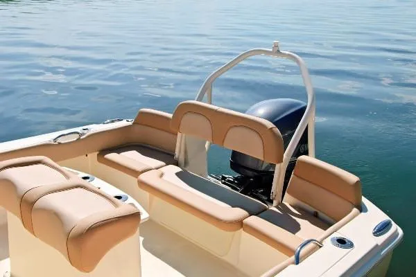 Slide: The Image of Manufacturer Provided Image: 2020 Scout 195 Sportfish boat interior with tan seating and outboard motor. - 8