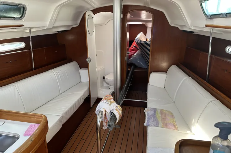 Slide: The Image of Interior of 2002 Beneteau First 36.7 sailboat with white seating and wooden accents. - 5