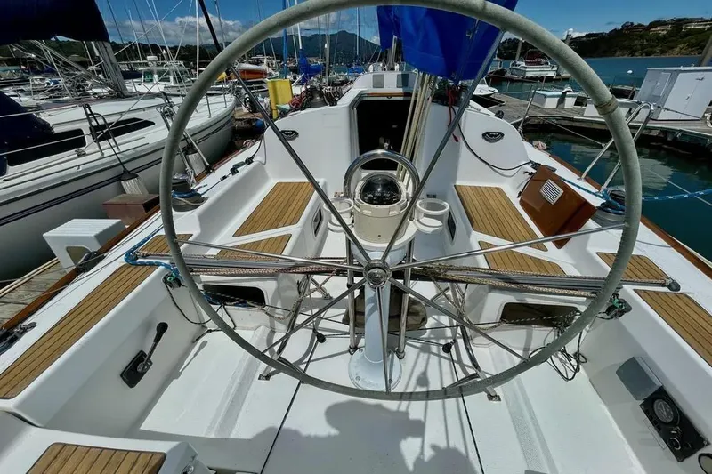 Slide: The Image of Cockpit of 2002 Beneteau First 36.7 sailboat with steering wheel and teak seating. - 3