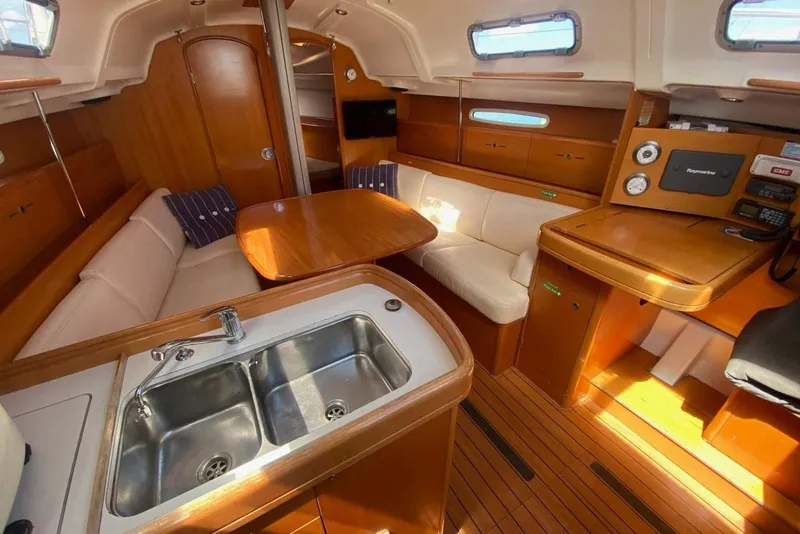 Slide: The Image of Interior of 2002 Beneteau First 36.7 yacht with wood finish and cozy seating area. - 5