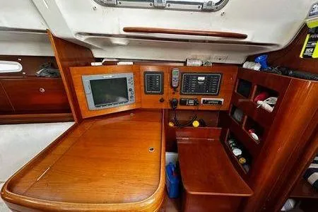Slide: The Image of Navigation station of a 2002 Beneteau First 36.7 yacht with electronic equipment and wooden cabinetry. - 6
