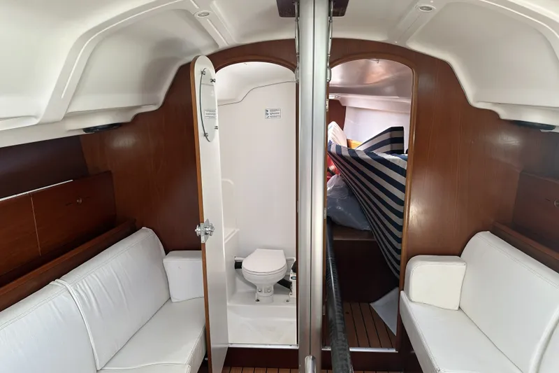 Slide: The Image of Interior of 2002 Beneteau First 36.7 yacht with white seating and wooden accents. - 8