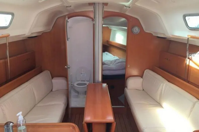 Slide: The Image of Interior of 2002 Beneteau First 36.7 yacht with cozy seating and wooden finishes. - 8