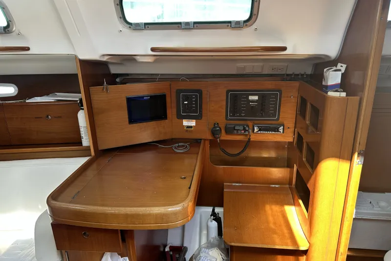 Slide: The Image of 2002 Beneteau First 36.7 yacht interior with navigation station and control panels. - 9