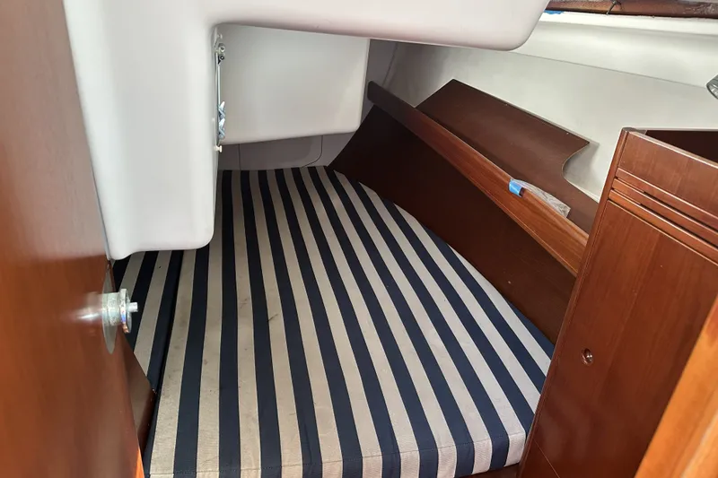 Slide: The Image of Interior cabin of 2002 Beneteau First 36.7 sailboat with striped mattress. - 7