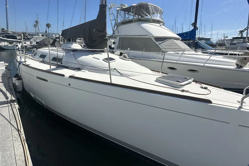 Slide: The Image of 2002 Beneteau First 36.7 sailboat docked at marina, sunny day. - 1