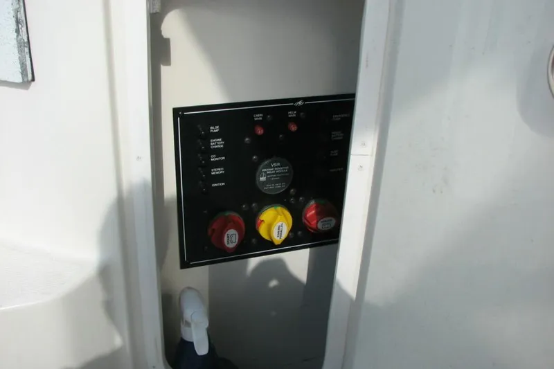 Slide: The Image of Control panel of a 2014 Monterey 280 Sport Yacht, featuring switches and dials. - 13