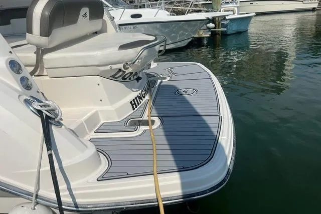 Slide: The Image of 2014 Monterey 280 Sport Yacht docked, featuring a spacious swim platform. - 2