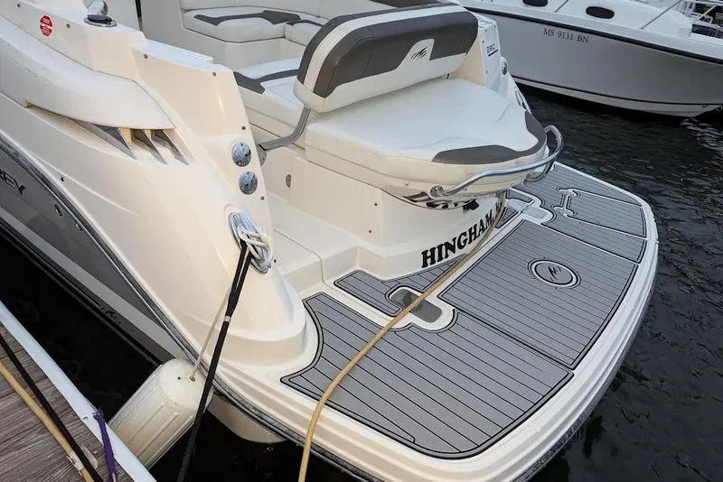 Slide: The Image of 2014 Monterey 280 Sport Yacht docked, featuring spacious rear deck and seating. - 3