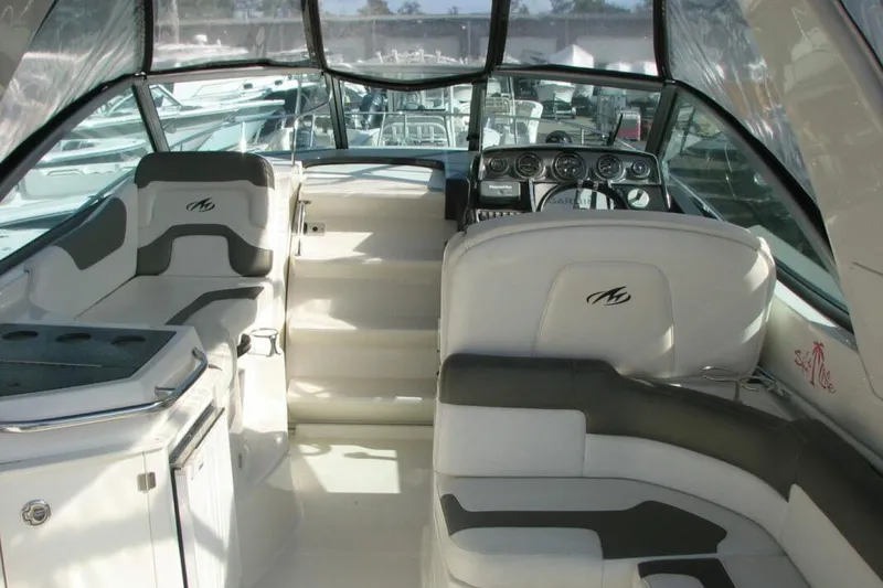 Slide: The Image of Interior of a 2014 Monterey 280 Sport Yacht with sleek seating and modern dashboard. - 4