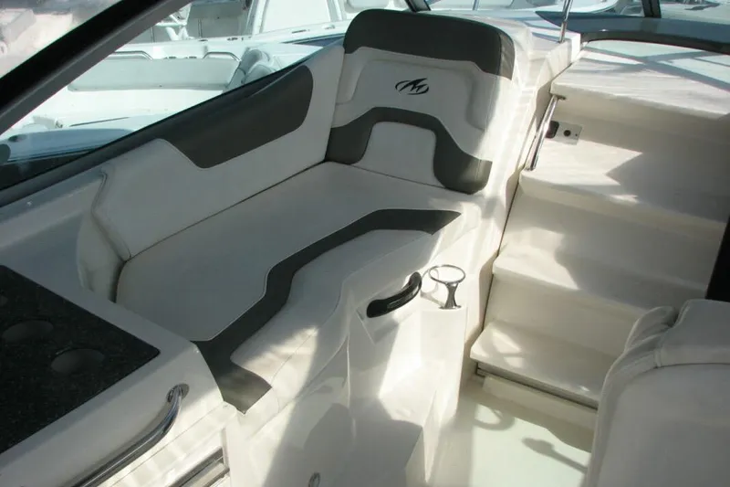 Slide: The Image of Interior seating of a 2014 Monterey 280 Sport Yacht, featuring sleek white and gray design. - 5