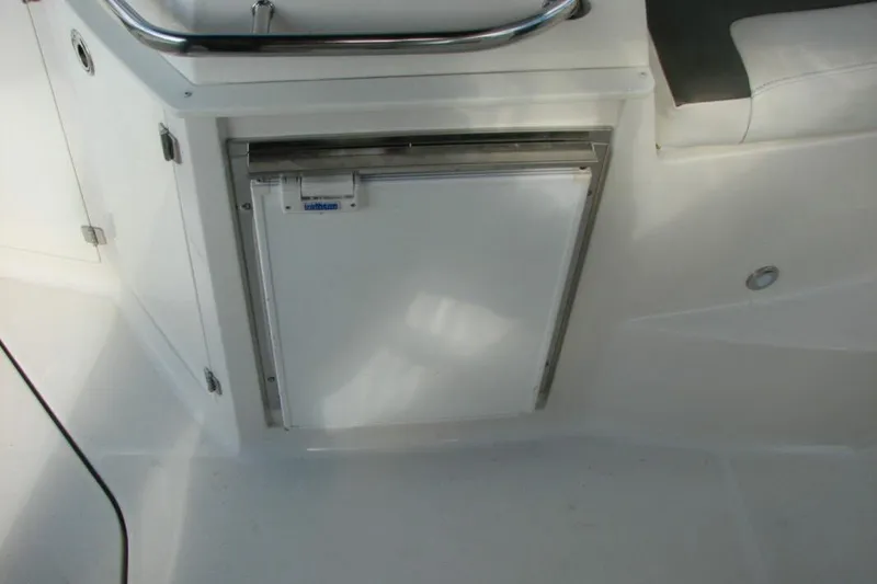 Slide: The Image of White interior of 2014 Monterey 280 Sport Yacht featuring a compact refrigerator. - 6