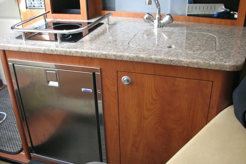 Slide: The Image of Compact kitchen area in 2014 Monterey 280 Sport Yacht with sink and stove. - 7